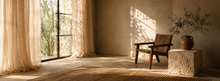 Sunlit minimalist room with linen curtains, wooden chair and warm natural textures