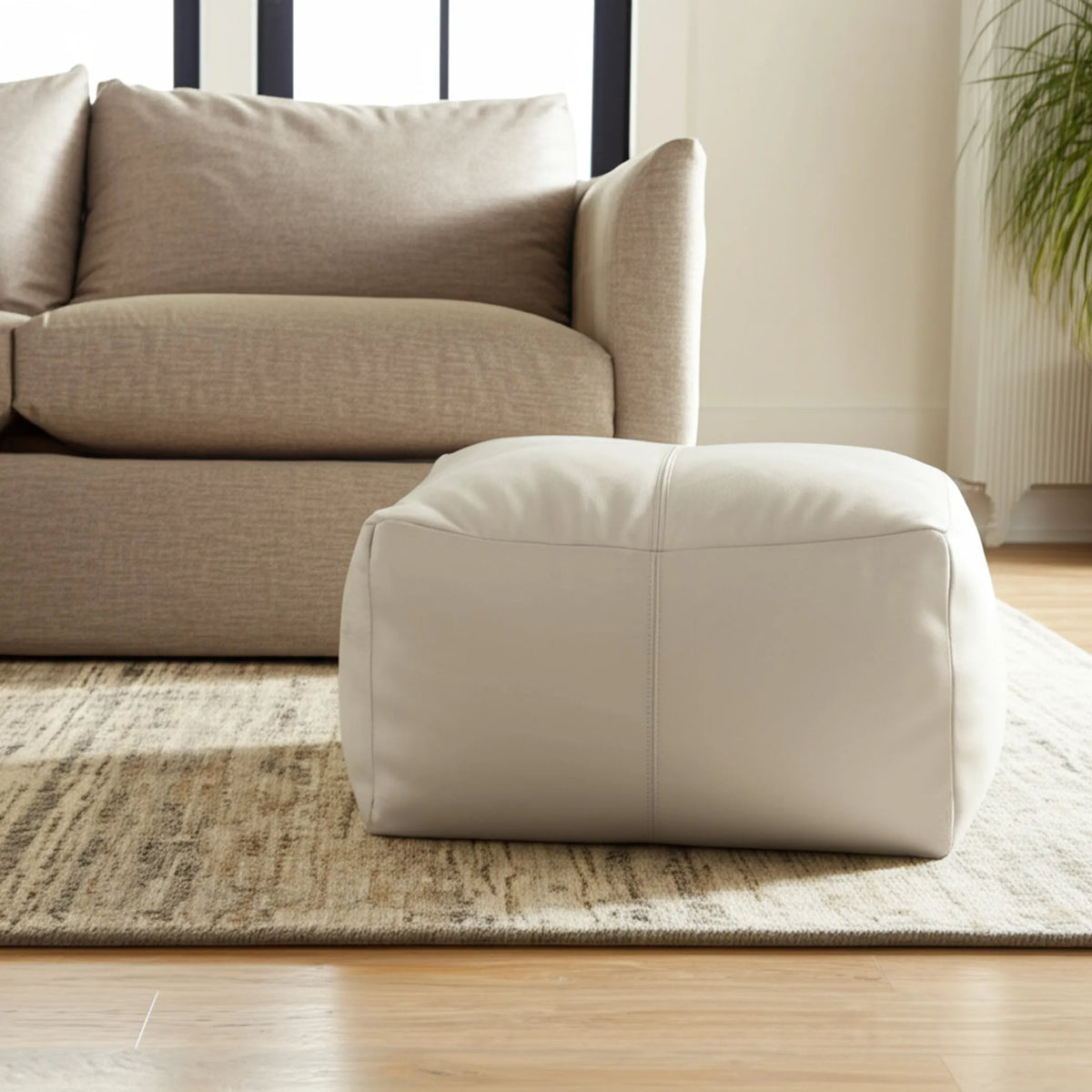 ivory leather pouf ottoman, side view