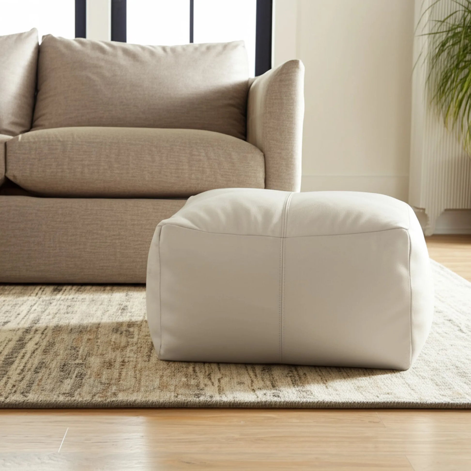 ivory leather pouf ottoman, side view