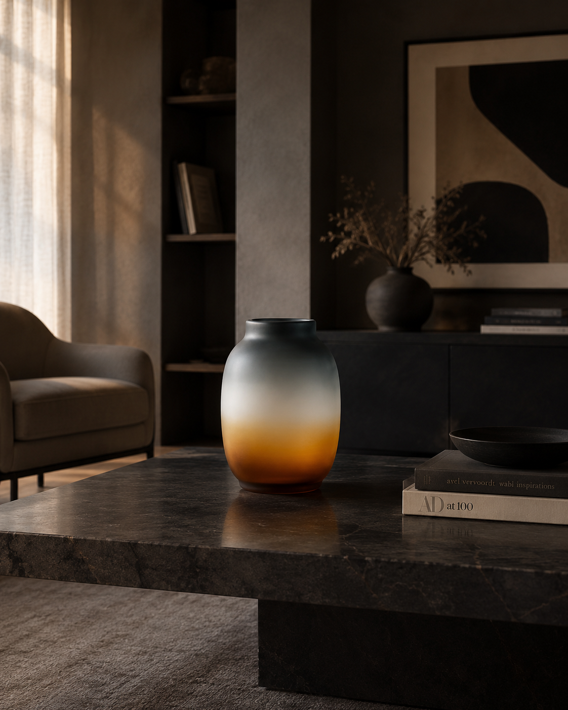 Sculptural charcoal and amber ombre vase displayed on a dark marble table in a sophisticated contemporary living room.