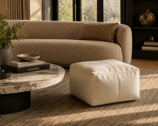 Ivory leather pouf ottoman in a living room