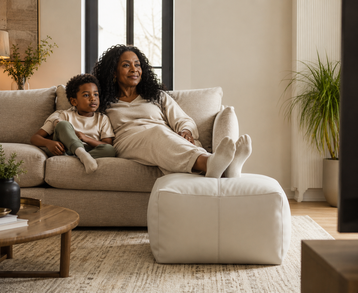Ivory leather pouf ottoman styled as footrest