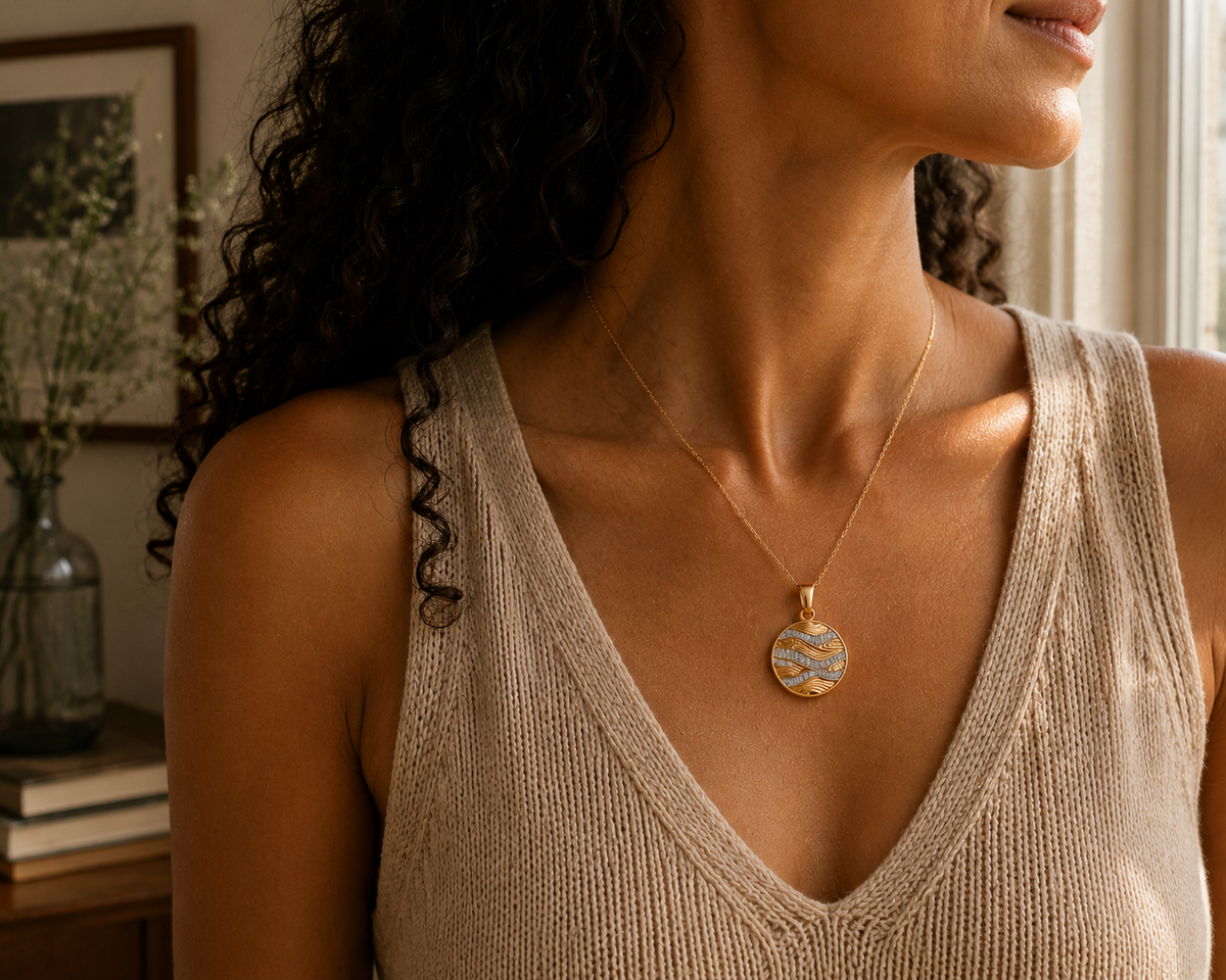 Gold cubic zirconia wave pendant worn around the neck