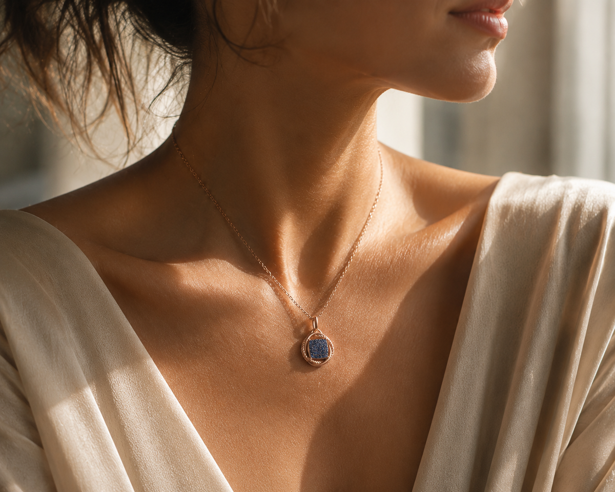 Rose gold and blue cubic zirconia drop pendant necklace worn around the neck